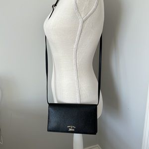 Gucci wallet with 22” adjustable and removable strap. Original dust bag & box.